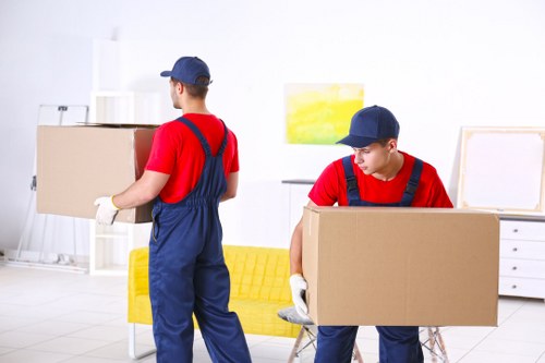 Stockwell van service worker loading boxes with safety focus