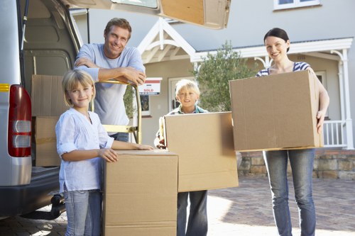 Professional movers carrying items down stairs in Stockwell