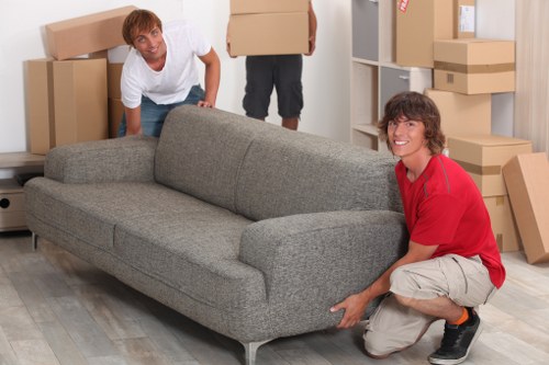 Professional movers loading furniture into a van in Stockwell
